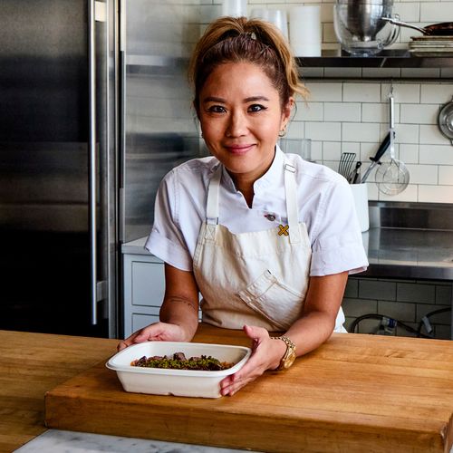 Chef Esther Choi plating a dish in her kitchen