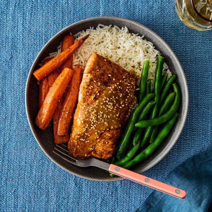 Miso-glazed salmon with sesame seeds, rice, roasted carrots, and green beans
